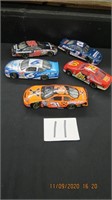 Lot of five die cast race cars. Hood and rear open