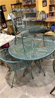 Green metal patio table with four matching patio