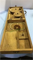 Vintage wooden box with either a tool or a toy,