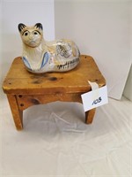 small wood stool with cat figurine