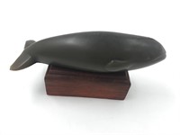 Resin figurine of a whale about 6" on hardwood bas