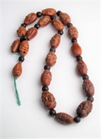 CHINESE CARVED PEACH PIT NECKLACE