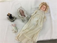 Dolls, one in baby carriage