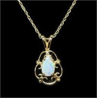 14K Yellow gold pear shape opal pendant with a