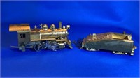 Small brass engine with empty coal car
