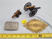 2 toy cannons, brass plaque, and belt buckle