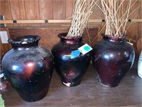 THREE POTTERY VASES WITH ARRANGEMENTS