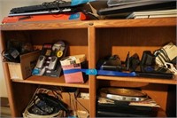 2 shelves of computer items and radios