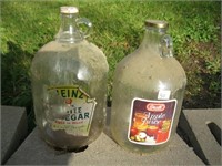 2 OLDER GLASS JUGS WITH LABELS