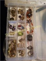 Plastic case full of earrings and misc jewelry