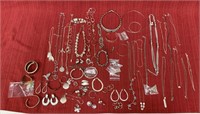 64 pieces of silver colored costume jewelry, 29