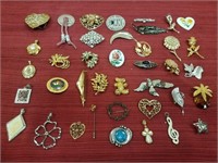 29 brooches, 10 necklace pendants, and a belt