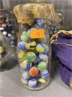 Vintage marbles in milk bottle