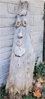 Weathered piece of wood with face, 61 inches tall