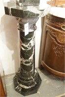 A black and White Marble Pedestal