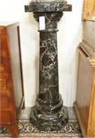 A black and White Marble Pedestal