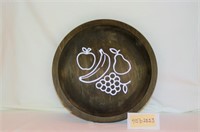round wooden plate with stenciled fruit