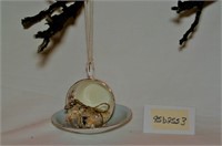 vintage cup and saucer bird feeder with bird seed