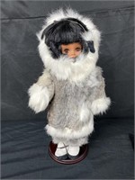 Eskimo doll with wooden stand