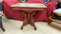 Antique wooden table on wheels. Measures 33x22x27