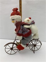 Snowman riding bike