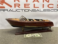 Chris Craft style wood model boat on display