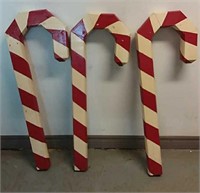 Three wooden candy canes 38"h