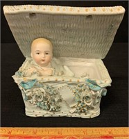 ORNATE VICTORIAN BISQUE BABY IN A BASKET FIGURINE
