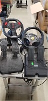 Lot of Video game steering wheels and foot pedals