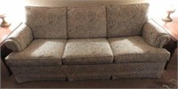 Three cushion upholstered sleeper sofa