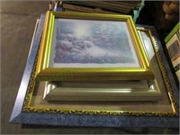 Stack of framed decorative photos and art