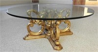 Glass top cocktail table with gold finish base