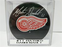 Signed #11 Mathieu Dandenault Red Wings Puck