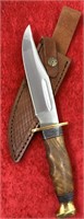 Hunting knife with brass guard and pommel, leather