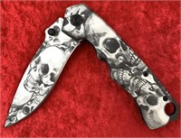 Spring assisted folding pocket knife with skull mo