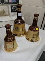 Three graduated 'Bells' whisky bottles (empty)