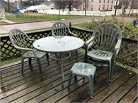 Green patio set table and four chairs with
