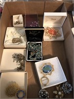 Flat of costume jewelry brooches