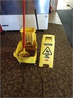 mop bucket and sign