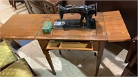 Antique Singer sewing machine, in the cabinet,