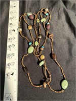 Very long necklace with lots of stones and beads