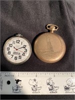 Two pocket watches - one with a train, the gold