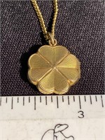 Gold four leaf clover picture Locket  on a very