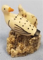 Vintage ivory carving of a bird in a rookery about