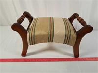 Vintage upholstered wood footstool.