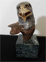 Bronze eagle head sculpture on a marble base