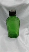 Antique Small green bottle with lid. Imprints in