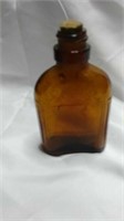 Small amber bottle with cork stopper. Imprinted