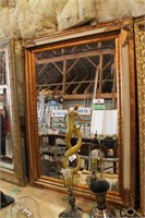 BEVELLED MIRROR WITH ELABORATE GOLD FRAME