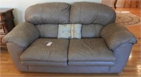 Lot #533 - Beige leather two cushion loveseat